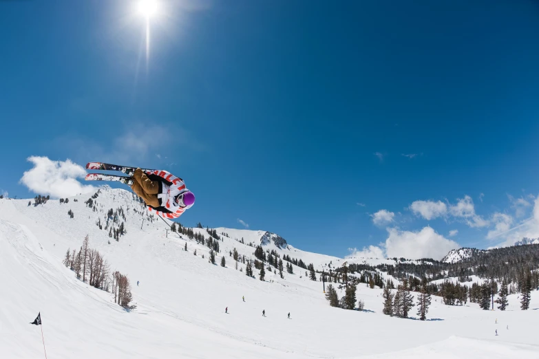 a person jumping off a hill on skis