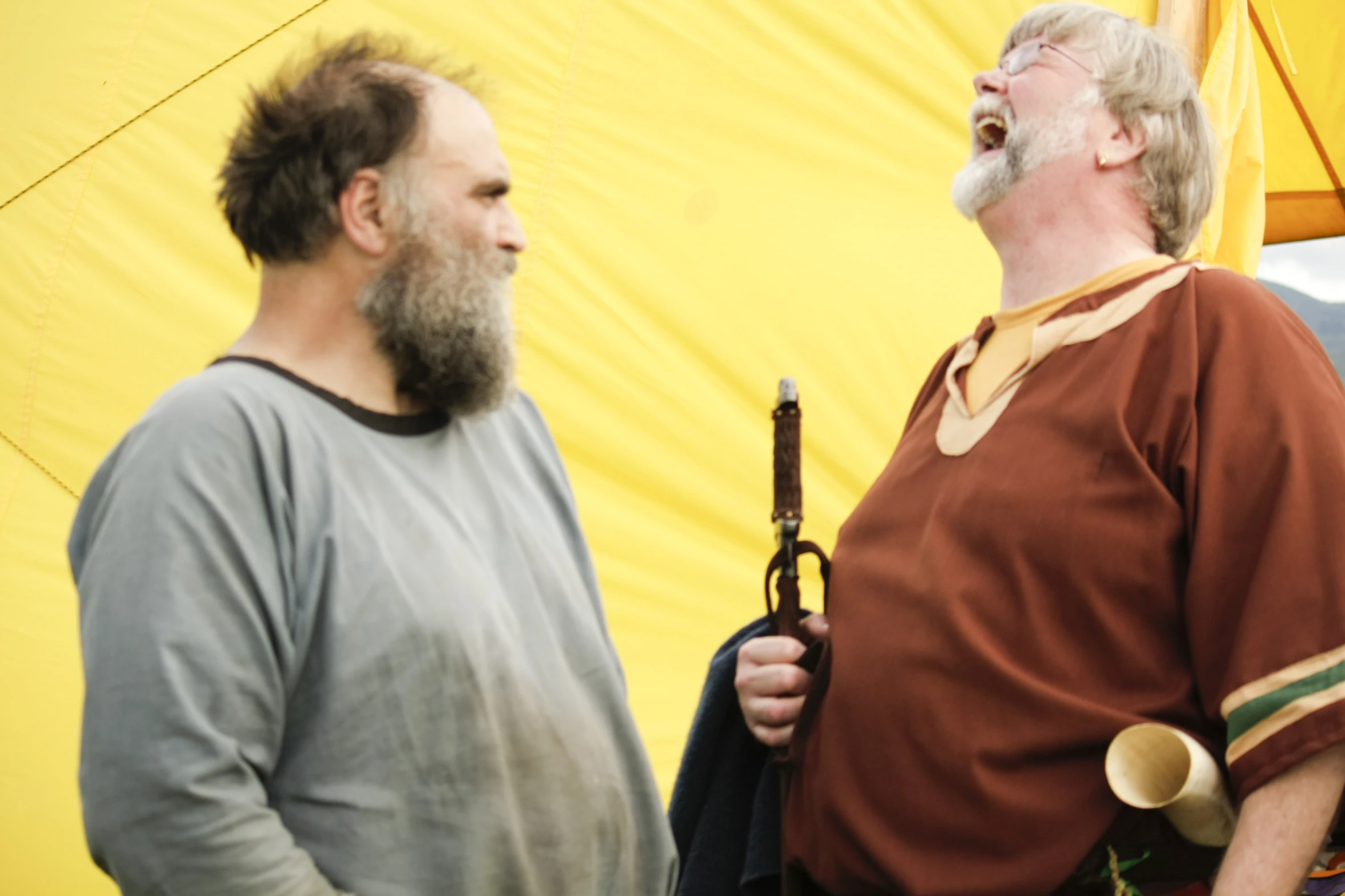 two people with one holding an umbrella and looking up