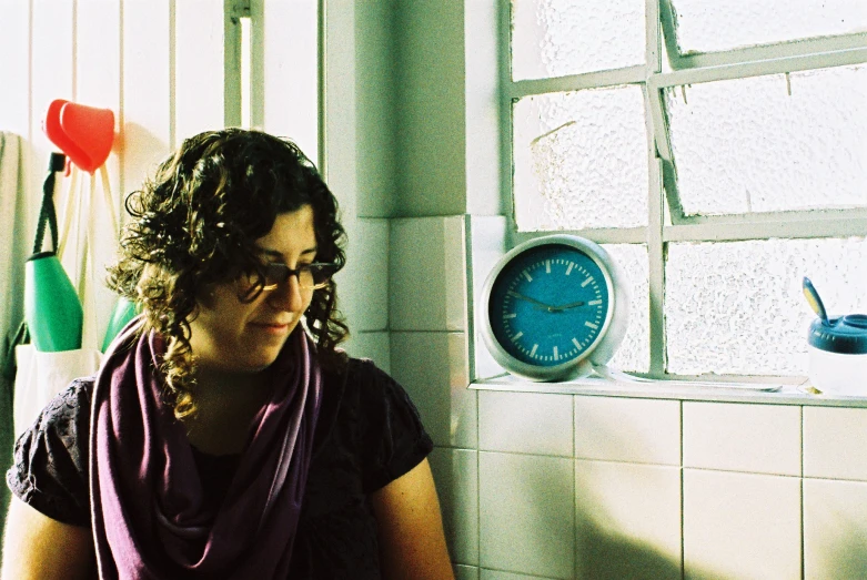 a woman that is sitting by a window