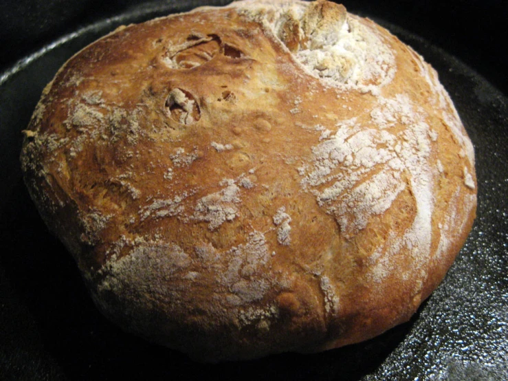 a freshly baked bread in a pan on top of the stove