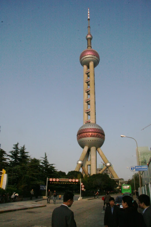 a large tall tower with many people in the street