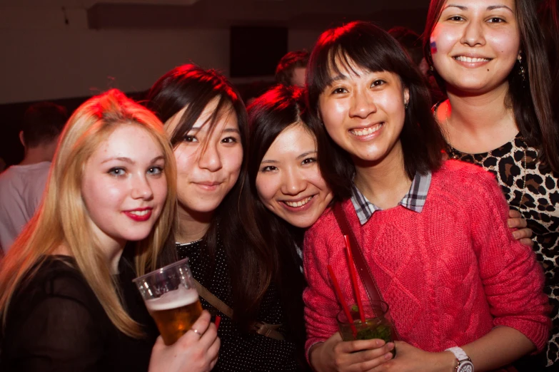 a group of pretty young women posing for a po