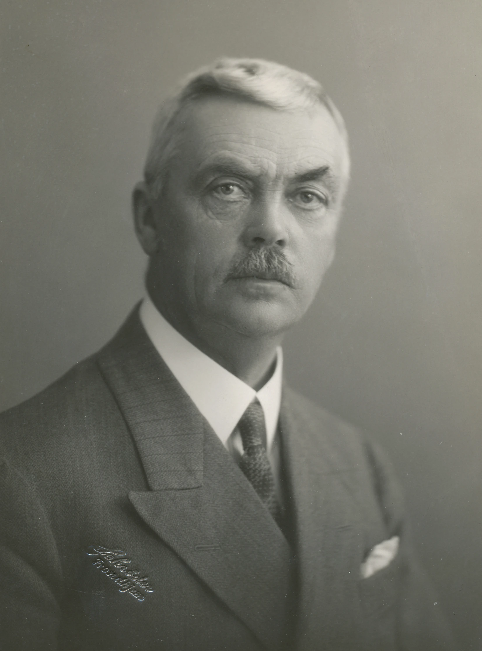 an old fashioned portrait of a man in a suit