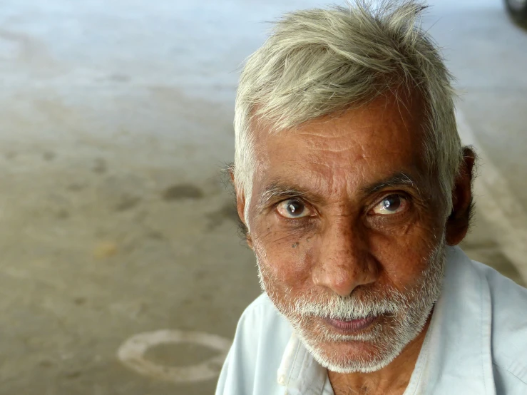 an older man is looking into the camera