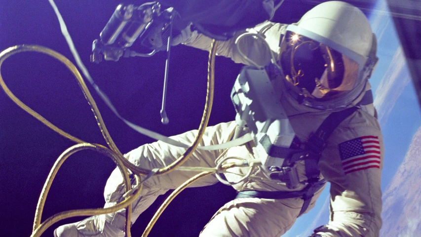 an astronaut with gloves and a helmet floating in space