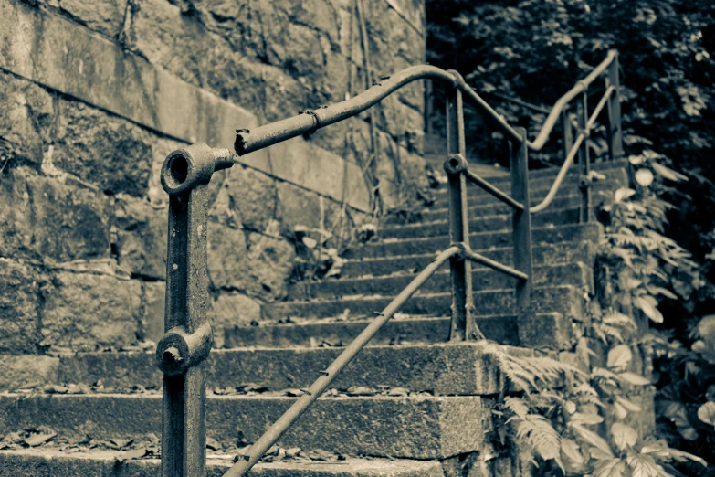 a stone wall with a stair case and metal railing