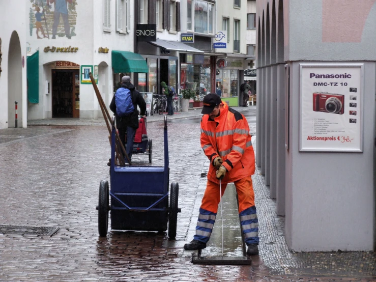a man is working with cleaning equipment in the rain