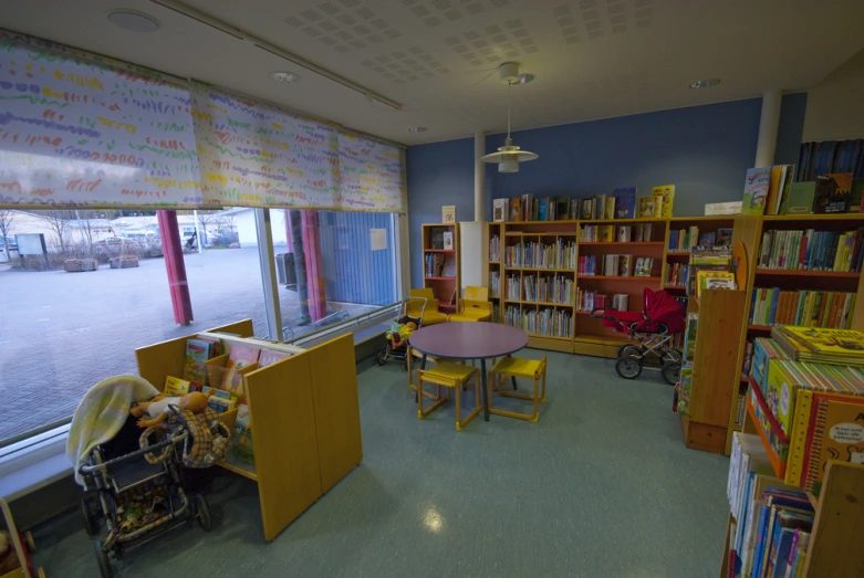 the playroom has various bookshelves and toys