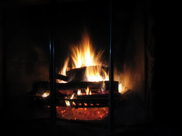 a fire burning in a fireplace with bright yellow flames