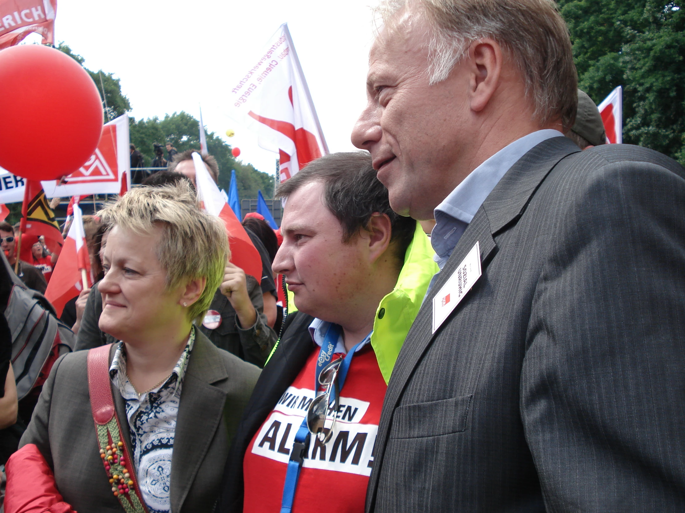 a man talking to people in front of flags