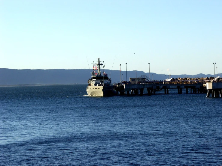 a boat is in the ocean by the dock