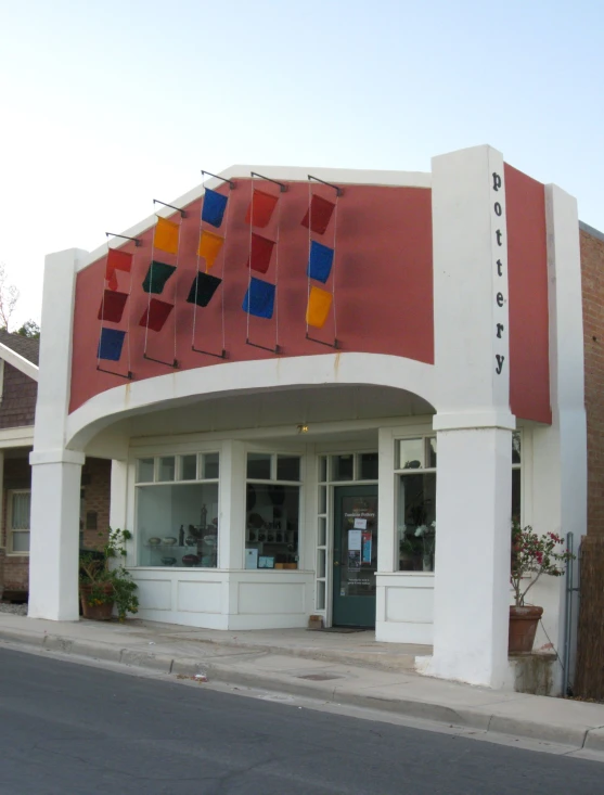 this building has a lot of colorful flags on the front