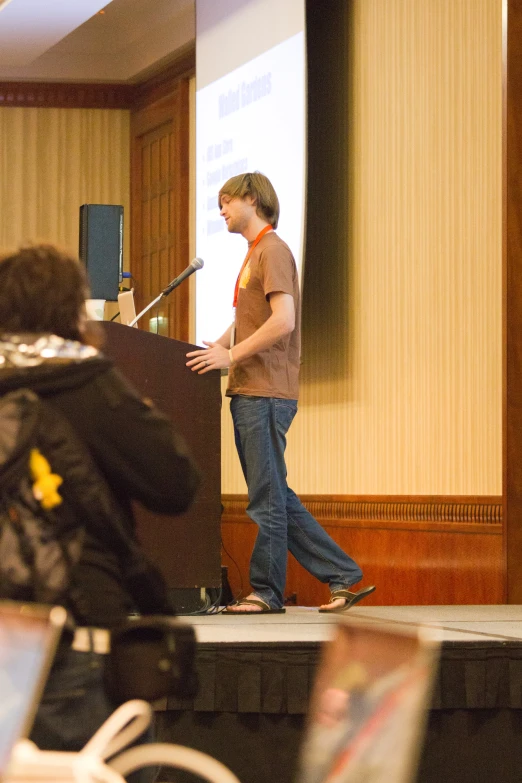 there is a man standing at the front of a large room