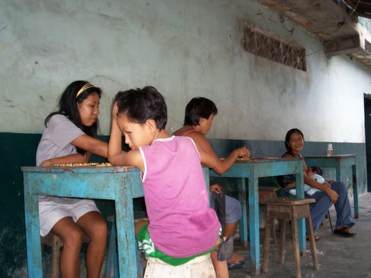 a group of people sitting at different blue tables