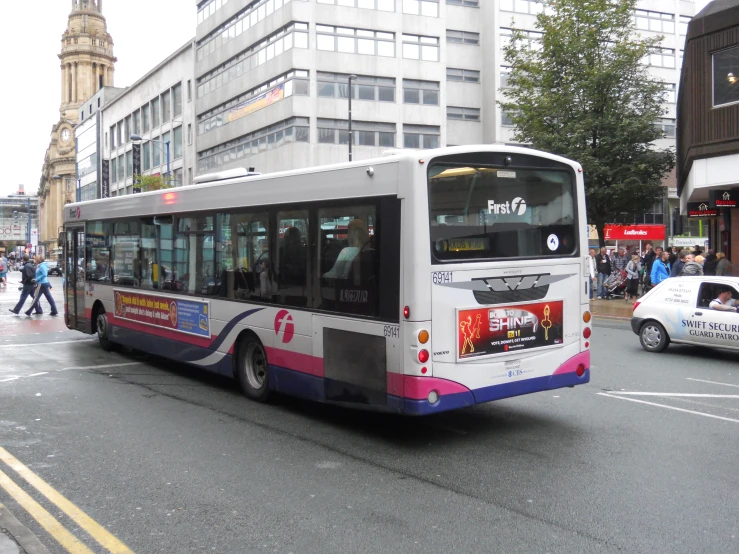 a city bus is stopped at an intersection