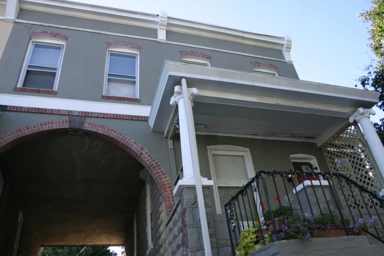 a house with a fence and an arch