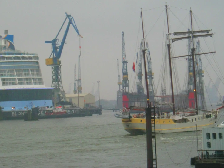 two ships are anchored near each other by a dock