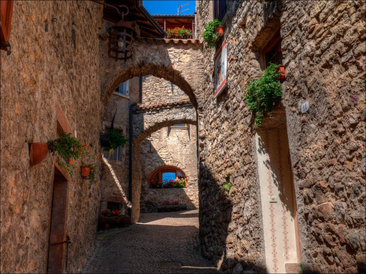 an arched alley leading to some buildings