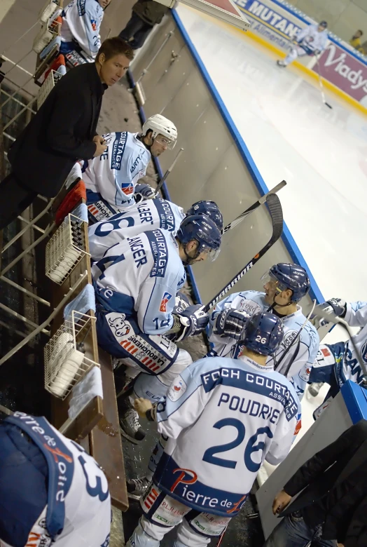 a hockey team huddled together on the ice