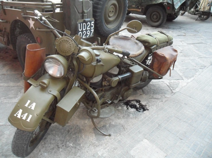 an army motorcycle with a side car behind it