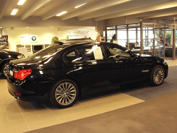 a bmw shop filled with two vehicles in the showroom