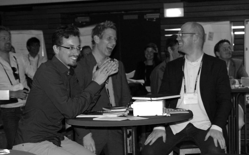 three people are having a conversation around a table