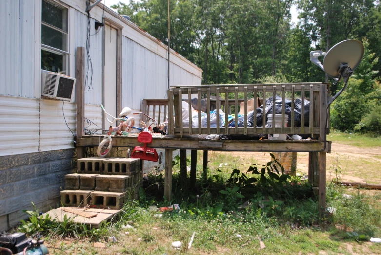 the building has several decks on it near a lawn