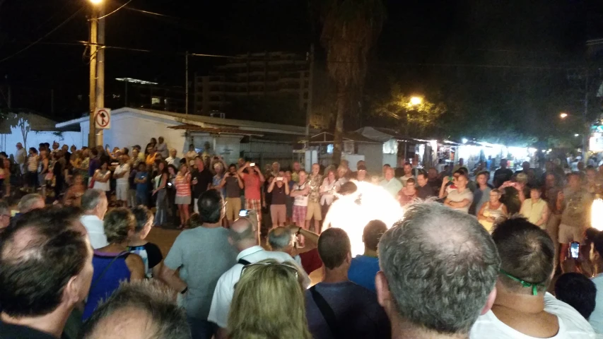 a crowd is gathered in front of a building