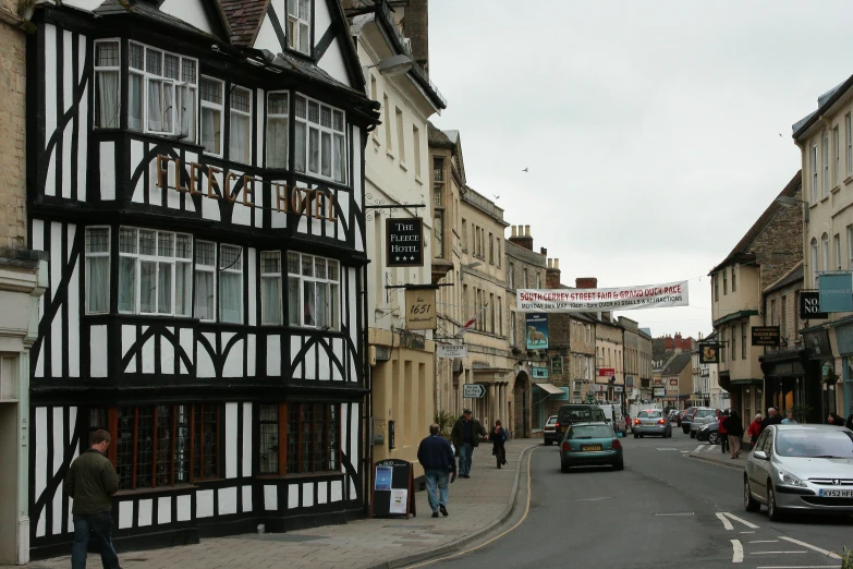 a large building with a group of people walking on the side of it