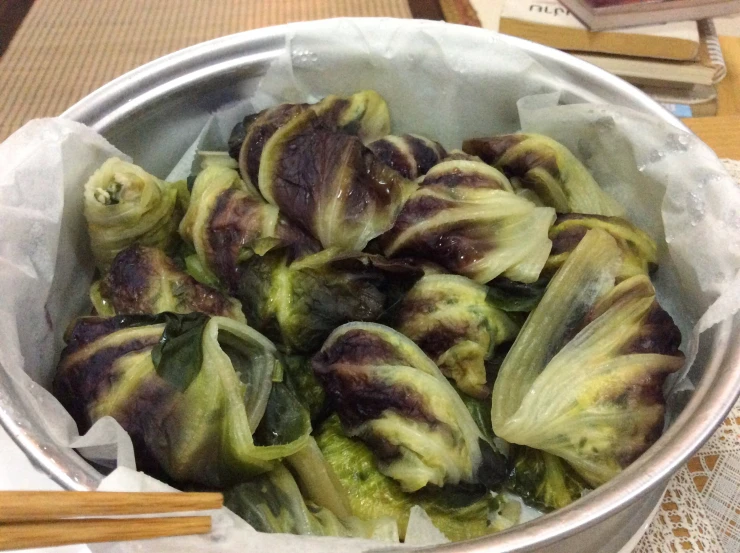 steamed green vegetable with brown and black leafy veggies