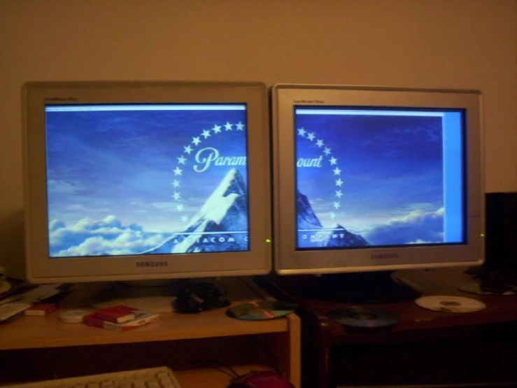 two computers turned on with the image being displayed