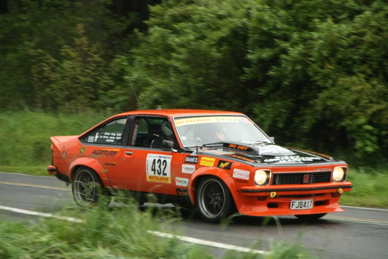 a red car with a number 39 driving on a road