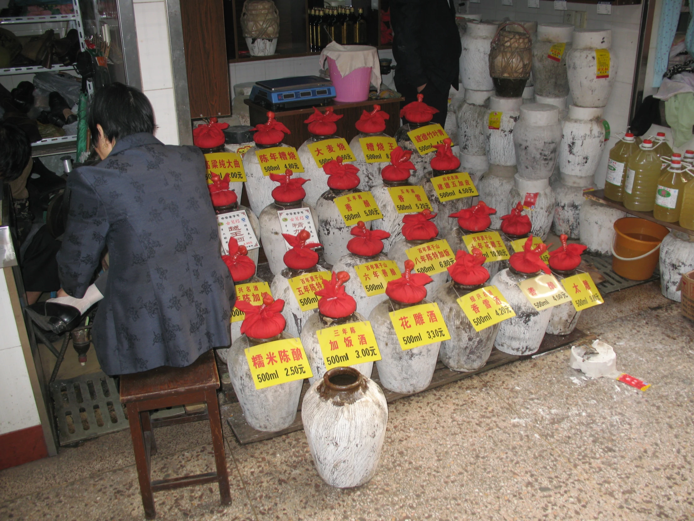 the man is arranging his ware in the shop