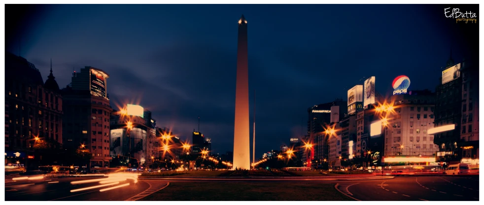 a tall obelisk in the middle of a city street