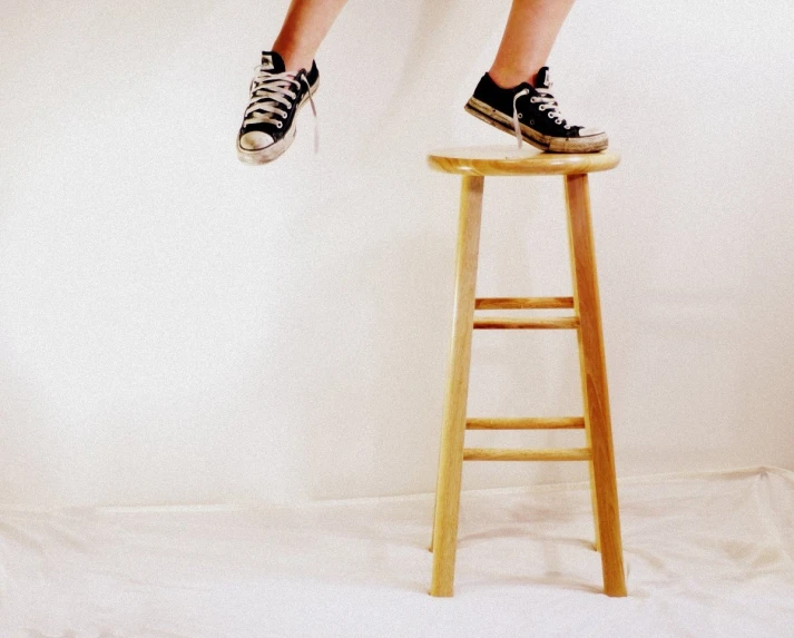 a small child on top of a chair near a wall