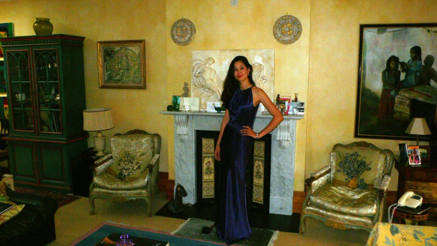 a woman posing in a living room with her arms on the waist