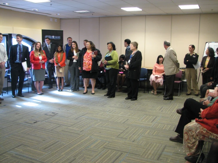 a group of people that are standing in front of a table