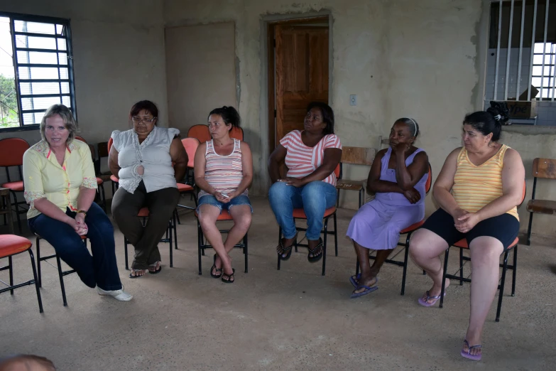 a group of women sit in a circle