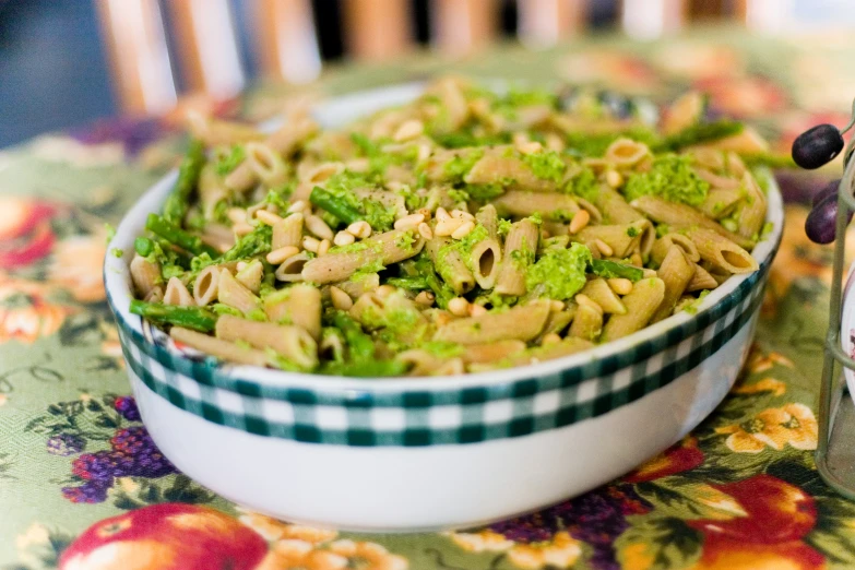a white bowl filled with pasta and broccoli