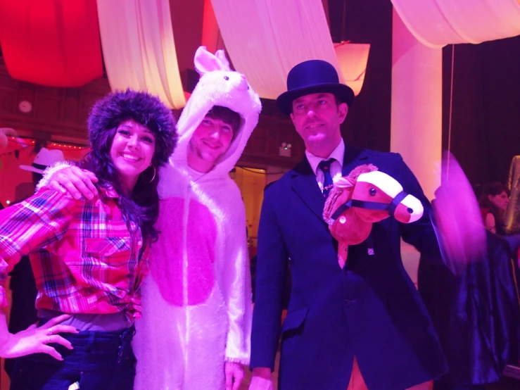 two ladies are dressed up as animals, and one man is dressed in a rabbit costume