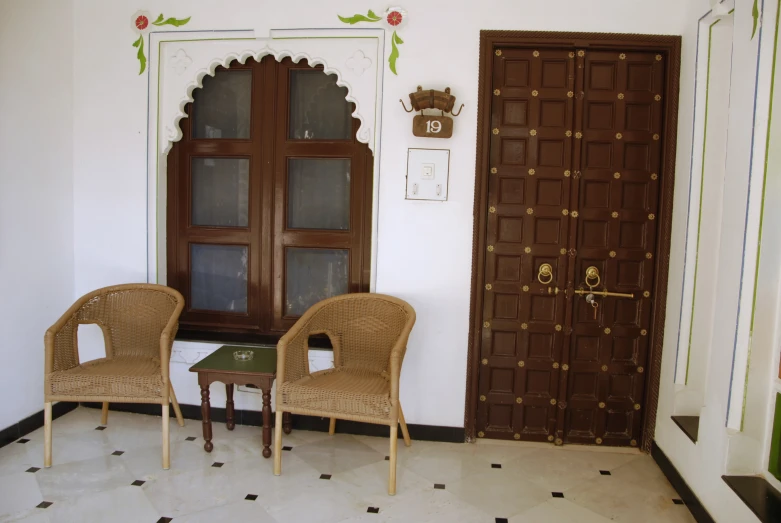 two chairs facing each other outside a room