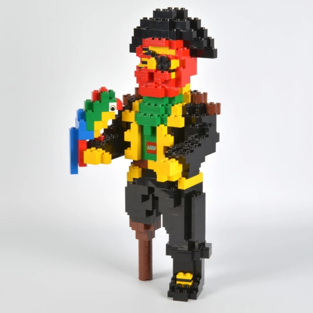 a lego man dressed as lego hero holding a lego toy gun