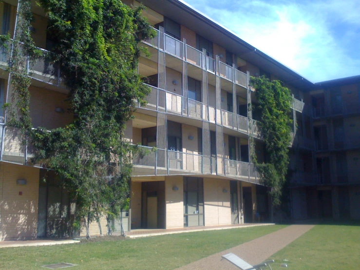 a building with trees growing on the balconies