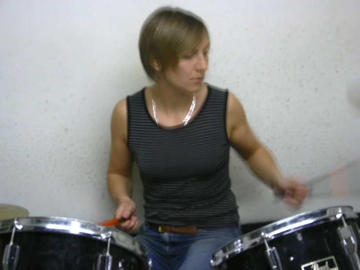 a person that is playing the drums and sitting