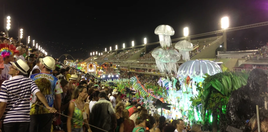 a large crowd of people standing around at a carnival