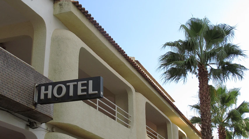the outside view of a motel building with palm trees