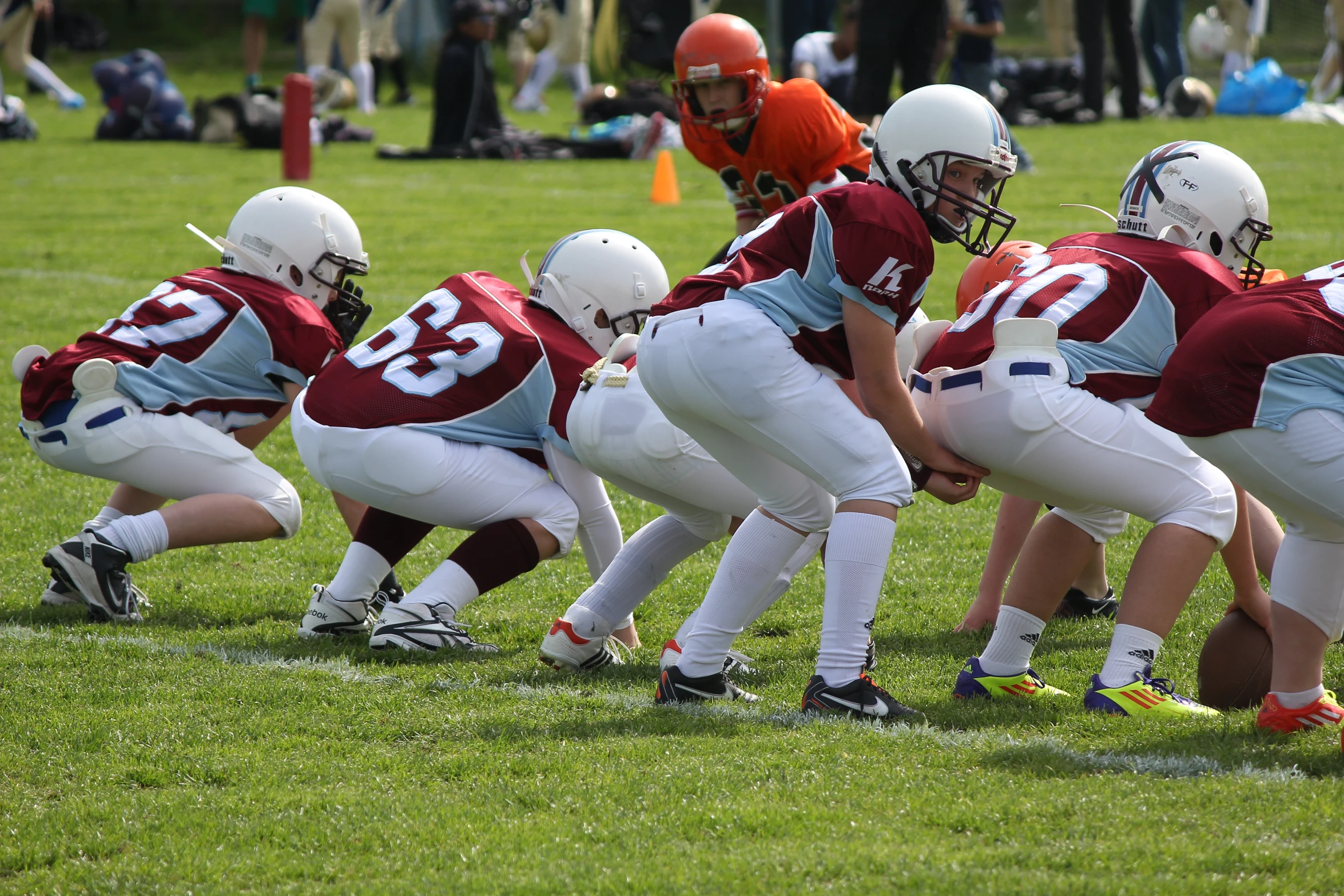 several young football players are lined up for a game