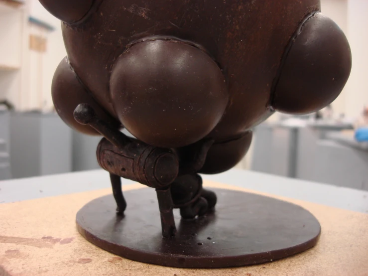 a small sculpture sitting on top of a wooden table