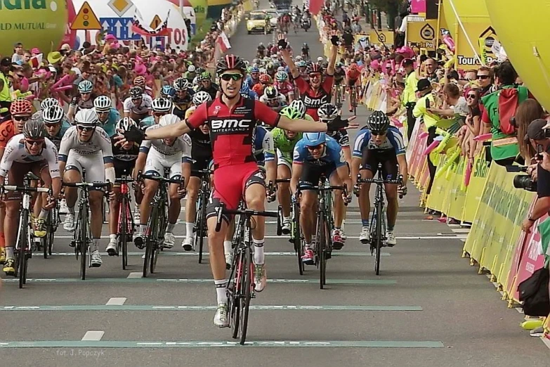 a group of cyclists racing down the road