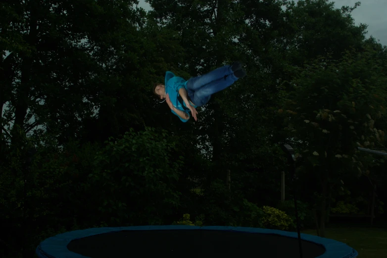 a person on a trampoline jumping in the air